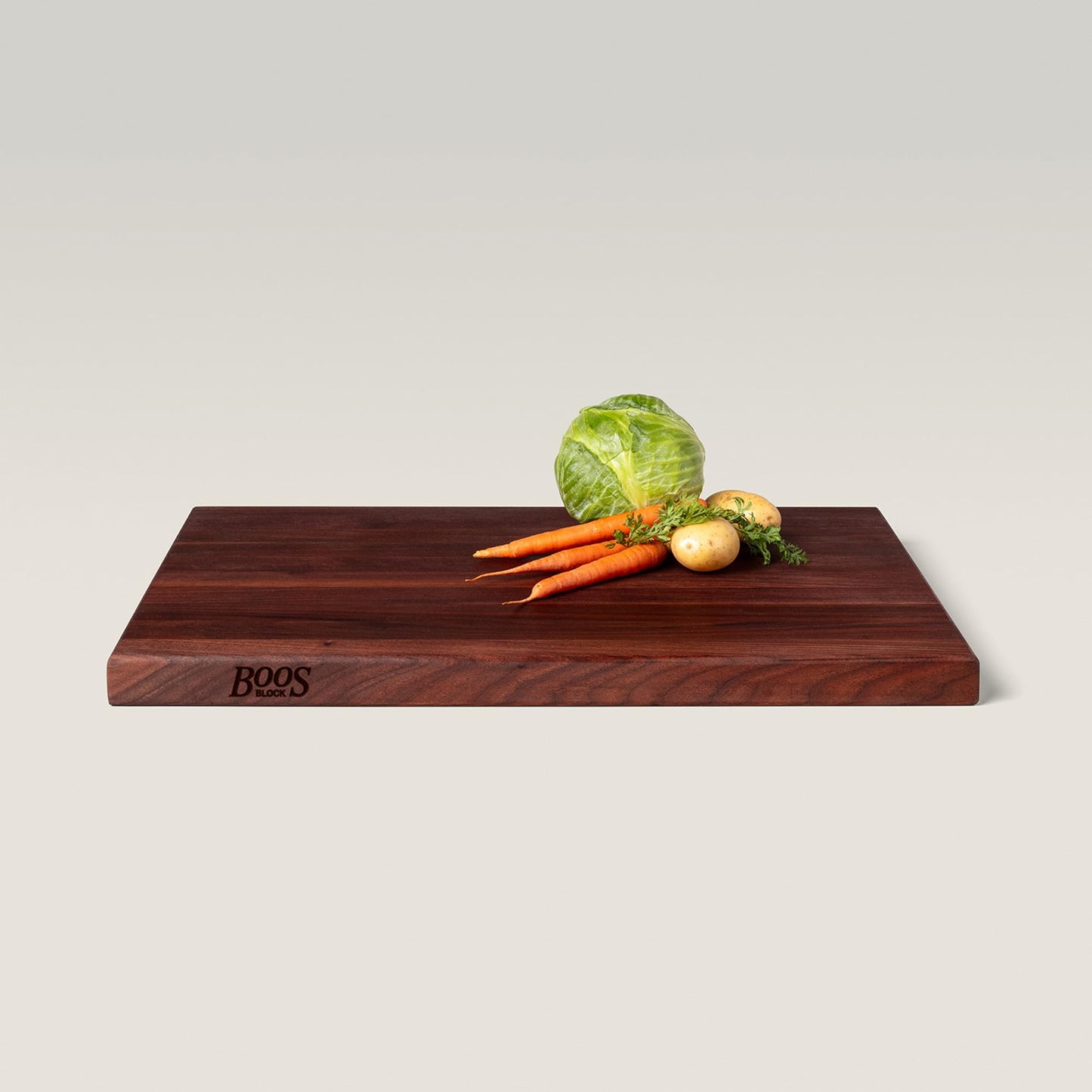 Wooden cutting board with vegetables on a light background