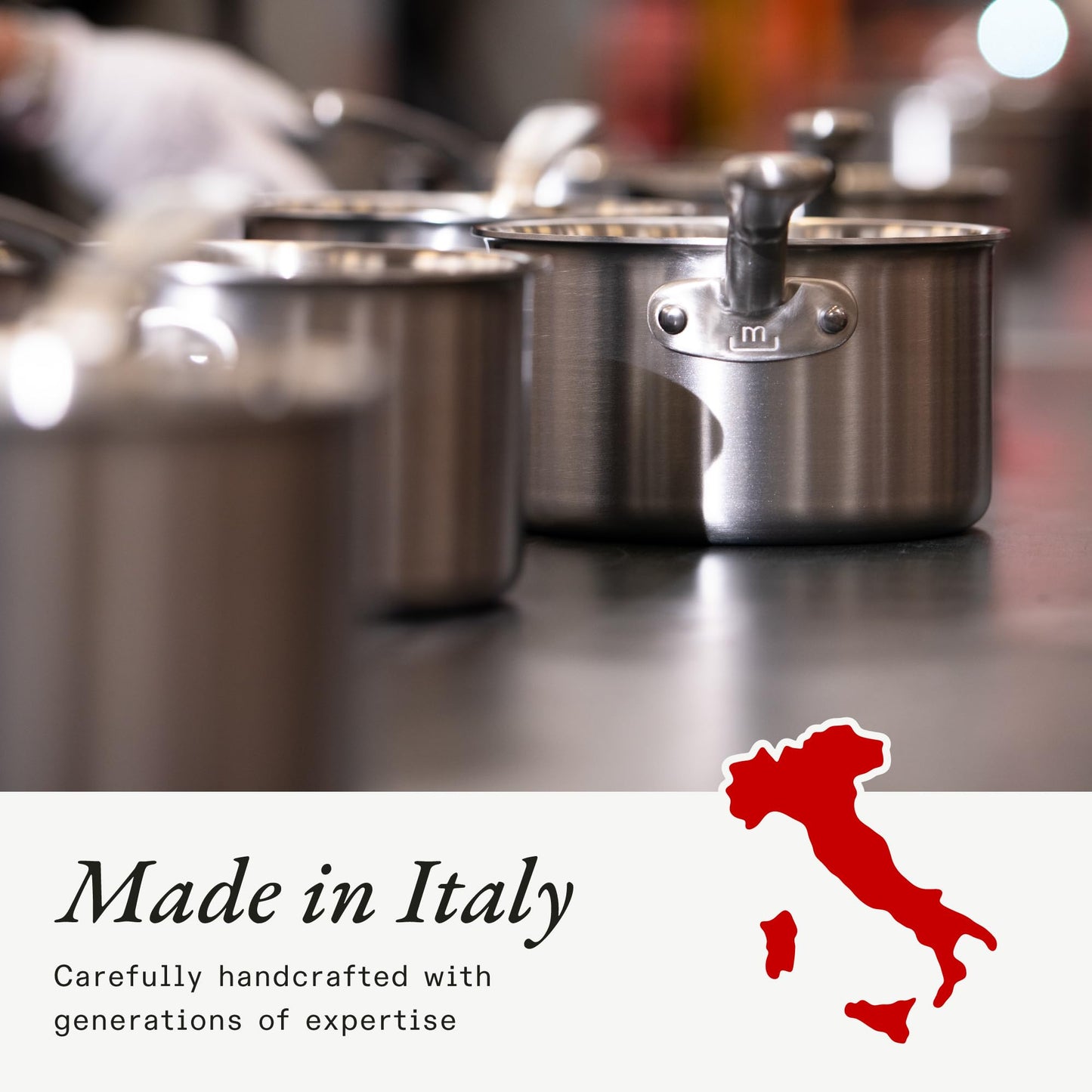 Stainless steel pots on a kitchen counter with 'Made in Italy' text and map.