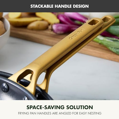 Gold handle of a frying pan with vegetables on a cutting board in the background