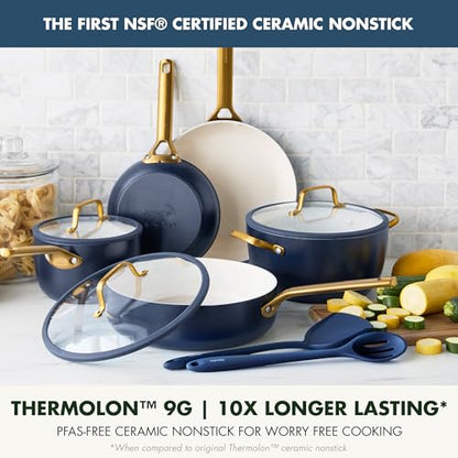 Set of ceramic cookware with gold handles on a kitchen counter.