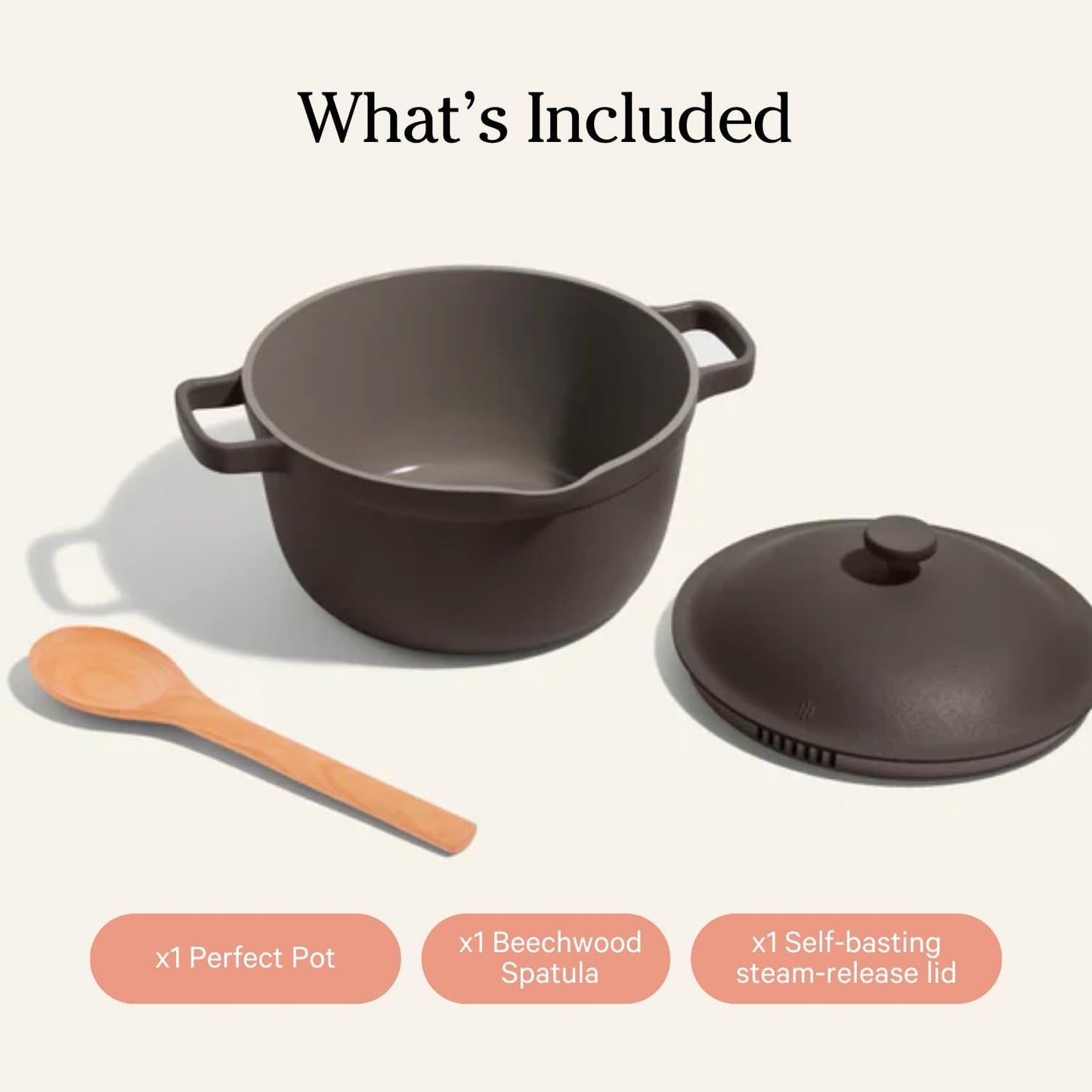 Dark gray pot with wooden spatula and steam-release lid on a white background