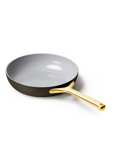 Gray frying pan with a gold handle on a white background