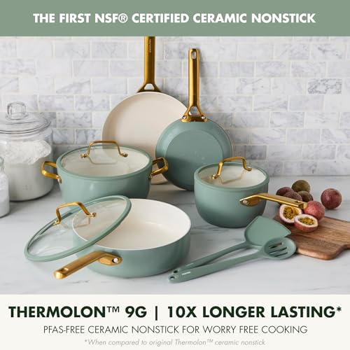 Set of ceramic cookware with gold handles on a kitchen counter.