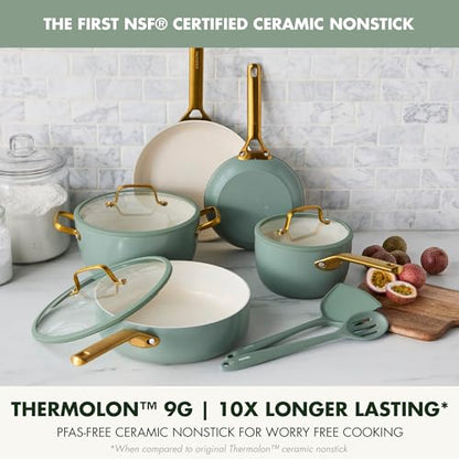 Set of ceramic cookware with gold handles on a kitchen counter.