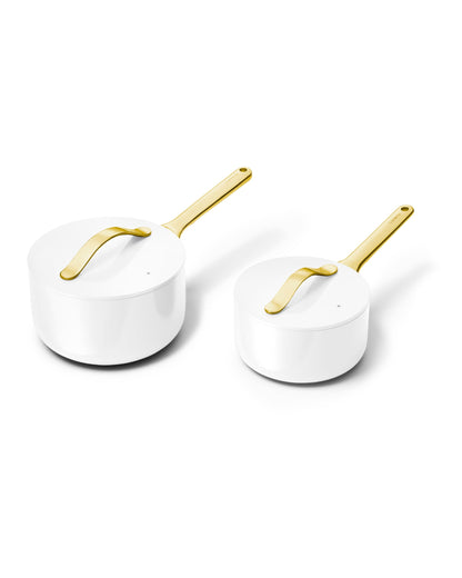 Two white pots with gold handles on a white background