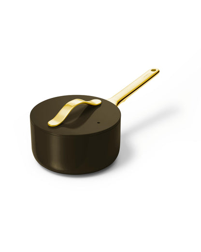 Black saucepan with a gold handle on a white background