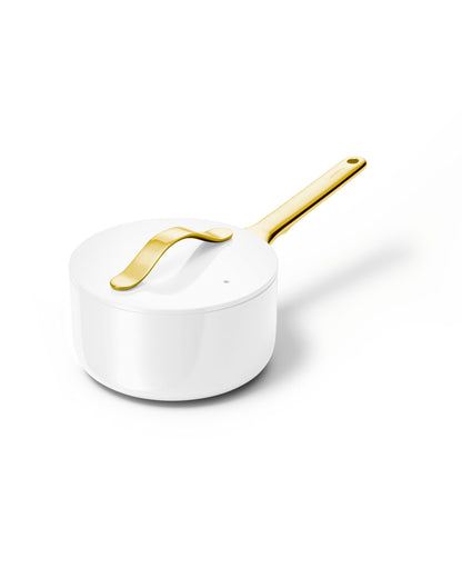 White saucepan with a gold handle on a white background