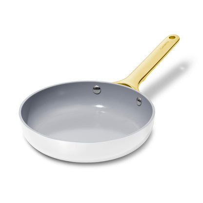 Gray frying pan with a gold handle on a white background