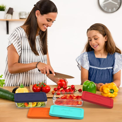 Woman and child preparing vegetables in a kitchen with colorful containers.