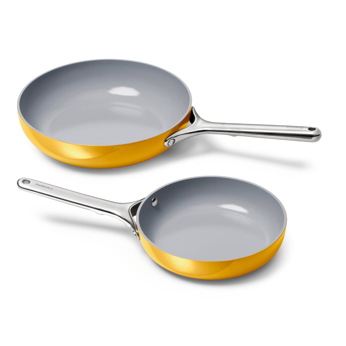 Two frying pans with gold trim and silver handles on a white background