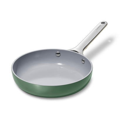 Green frying pan with a silver handle on a white background