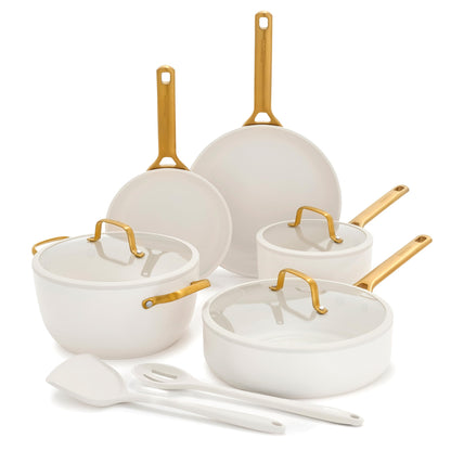 Set of white cookware with gold handles on a white background