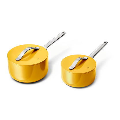 Two yellow cookware pots with lids on a white background