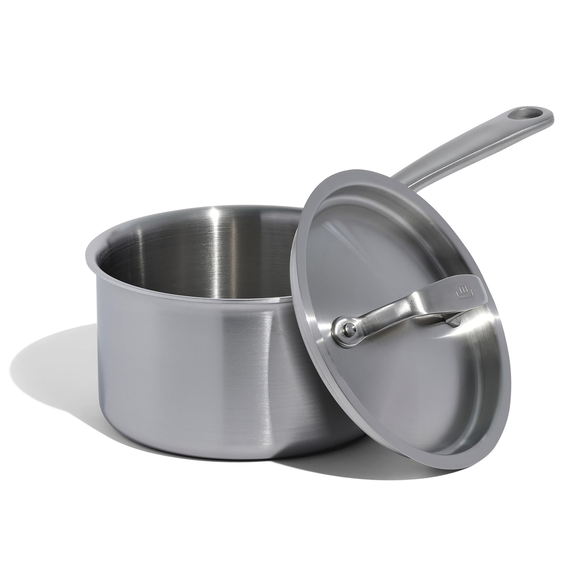 Stainless steel saucepan with lid on a white background