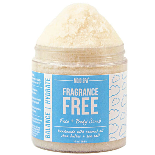 A jar of Mojo Spa Fragrance Free Face and Body Scrub, showing the textured beige scrub piled on top of a clear plastic jar with a blue and white label.