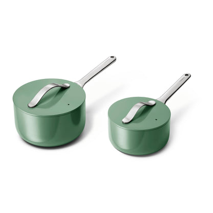 Two green pots with silver handles on a white background