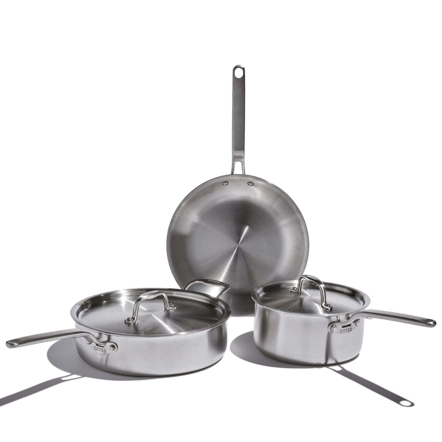 Set of stainless steel cookware on a white background