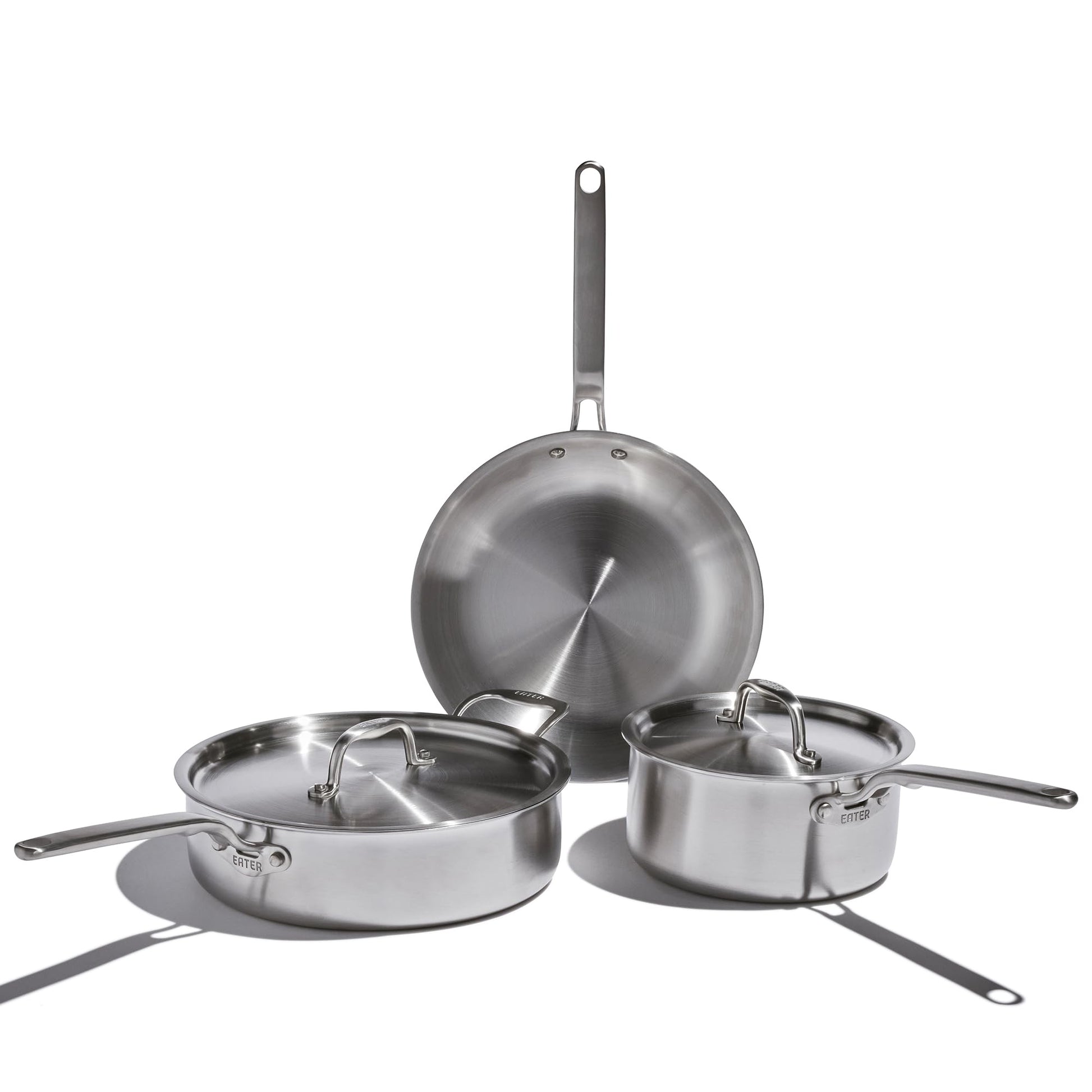 Set of stainless steel cookware on a white background