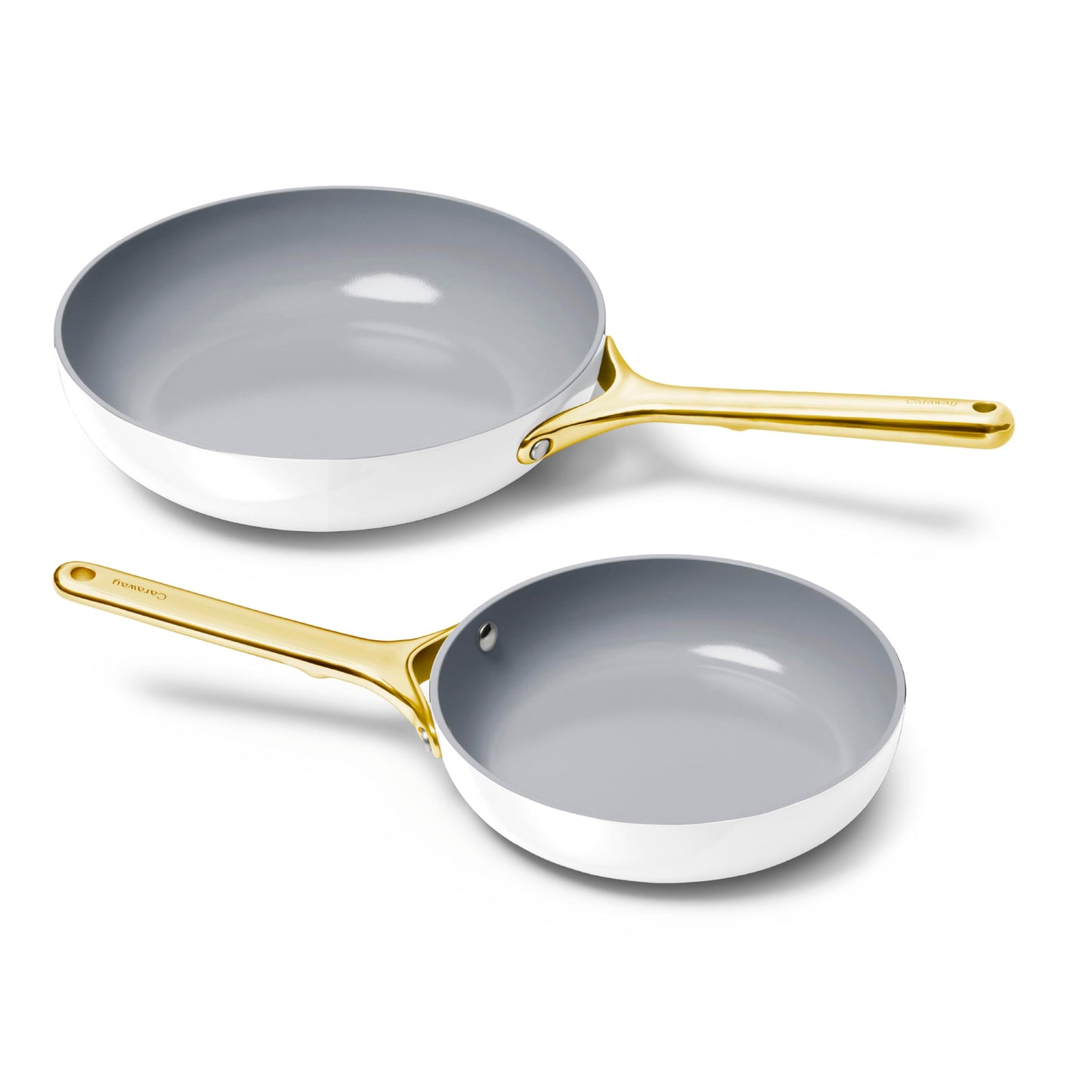 Two gray frying pans with gold handles on a white background