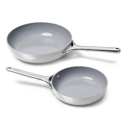 Two gray frying pans with handles on a white background