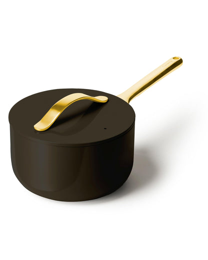 Black saucepan with gold handle on a white background
