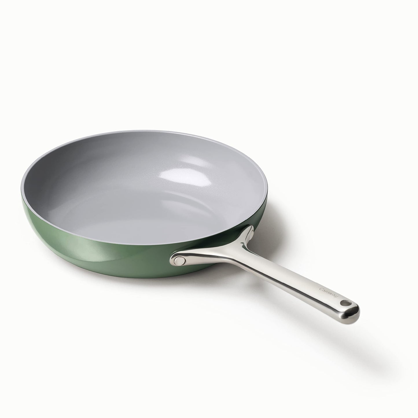 Green frying pan with a silver handle on a white background