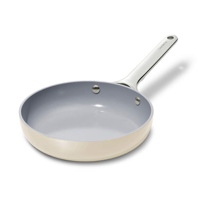 Frying pan with a gray interior and beige exterior on a white background