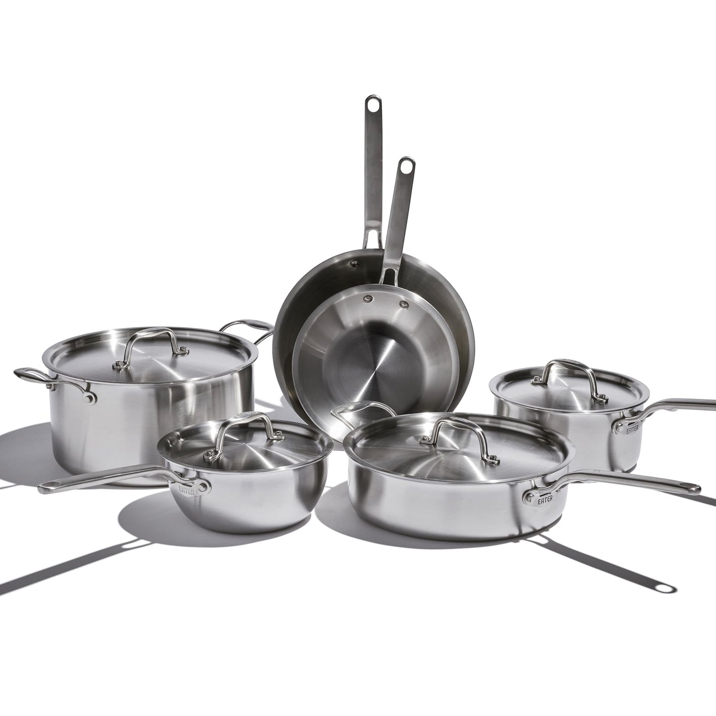 Set of stainless steel cookware on a white background