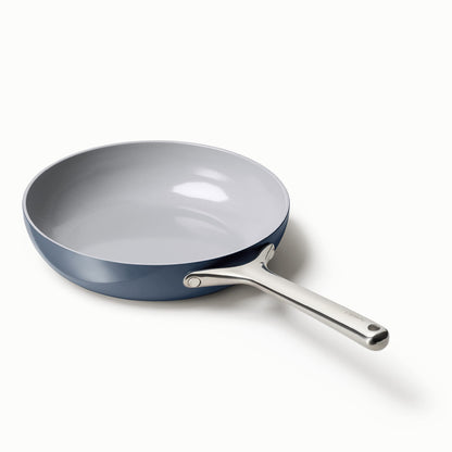 Blue frying pan with a silver handle on a white background