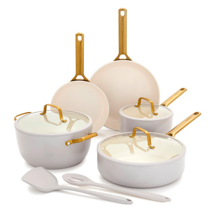 Set of ceramic cookware with gold handles on a white background