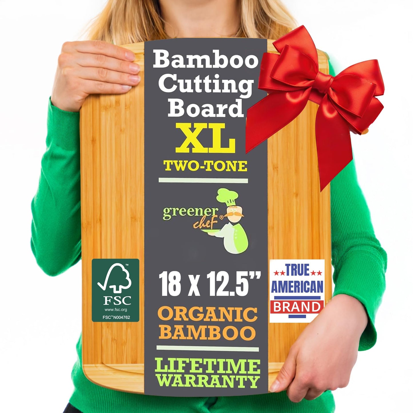 Bamboo cutting board with a red bow held by a person wearing a green shirt.