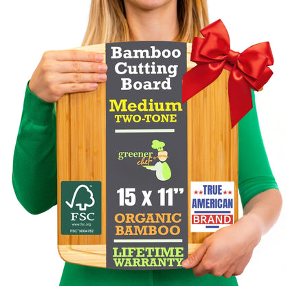 Person holding a bamboo cutting board with a red bow, packaging details visible