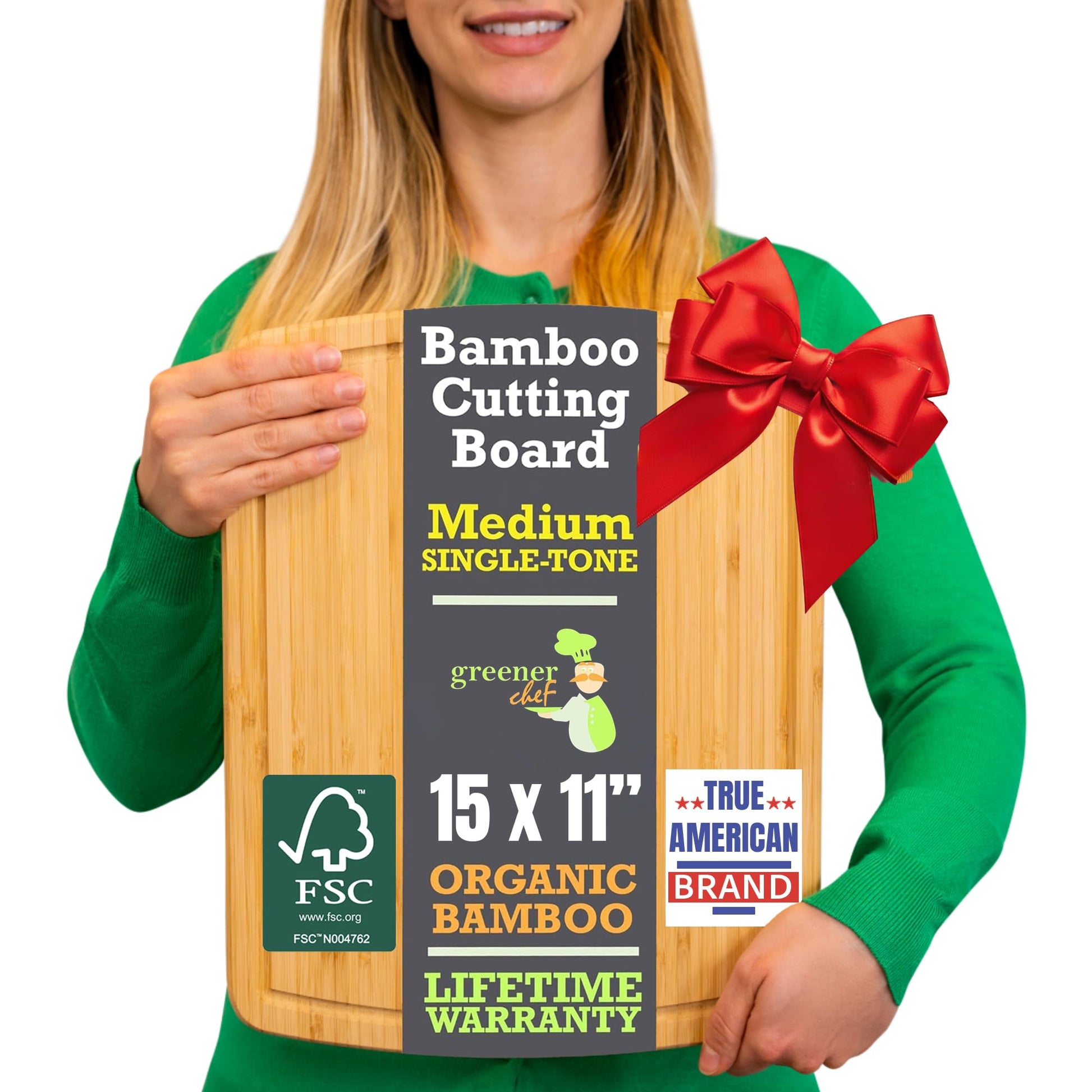 Person holding a bamboo cutting board with a red bow, labeled as an organic product.