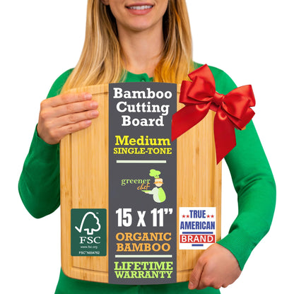 Person holding a bamboo cutting board with a red bow, labeled as an organic product.