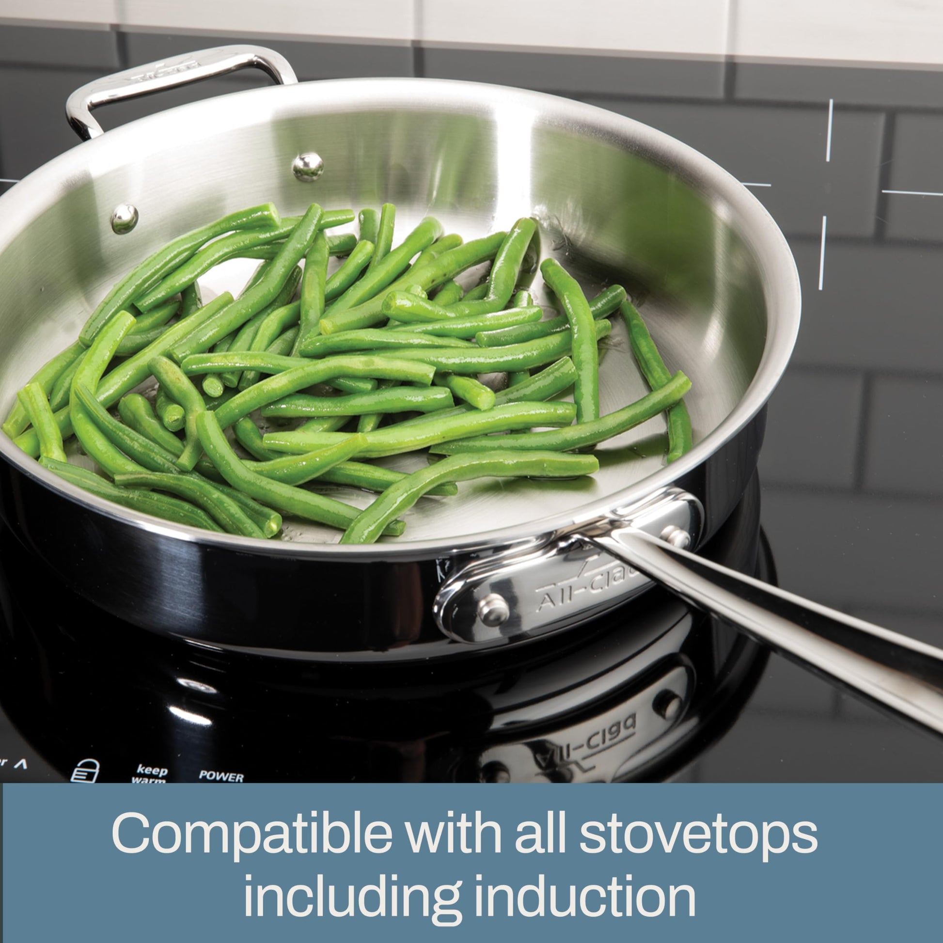 Stainless steel pan with green beans on a stovetop, text indicating compatibility with all stovetops including induction.