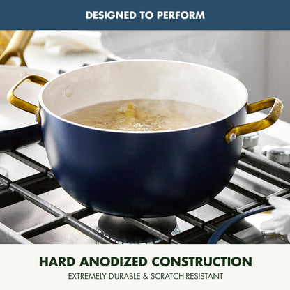 Blue pot with gold handles on a stove, featuring text about hard anodized construction.