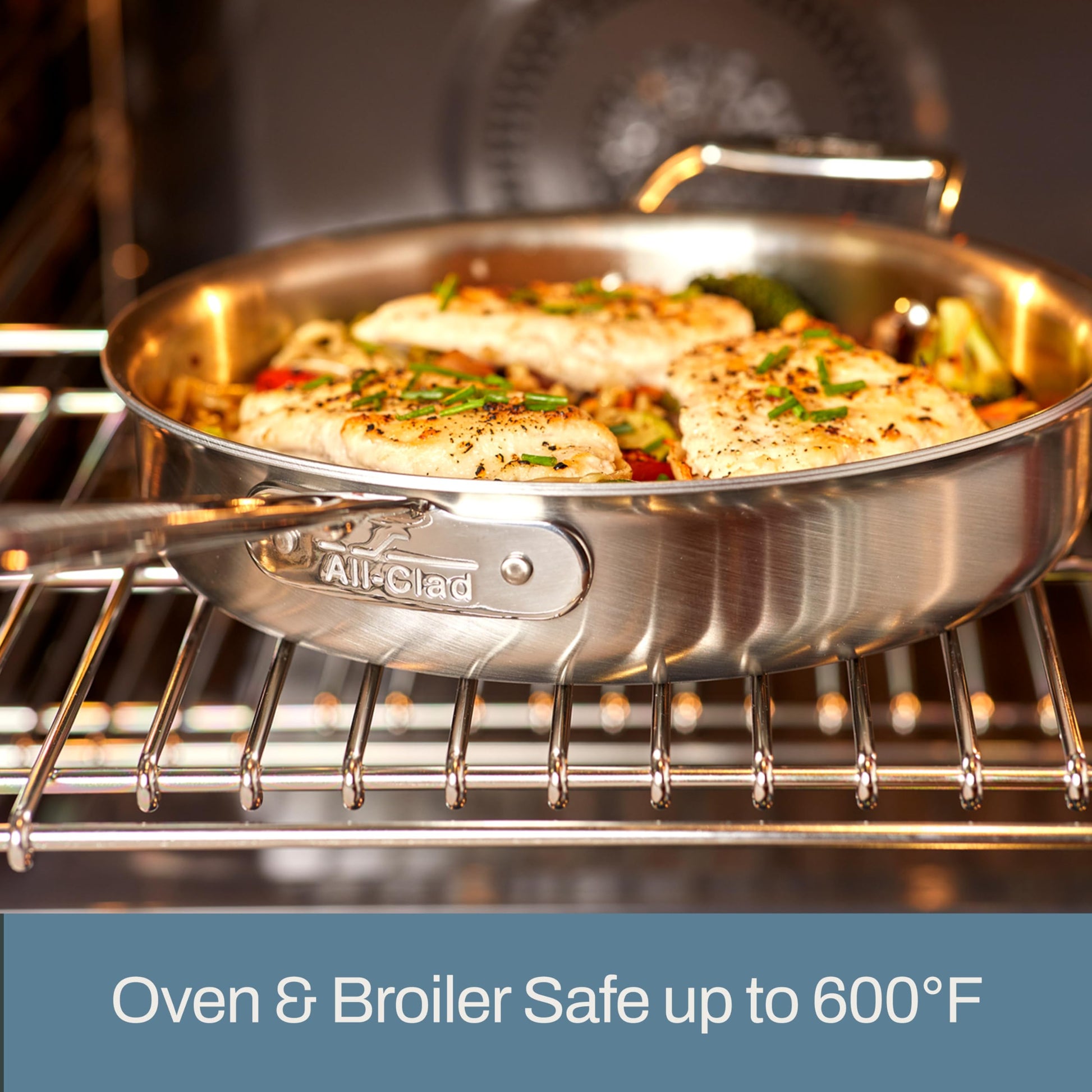 Stainless steel pan with food on a stovetop, featuring All-Clad branding.
