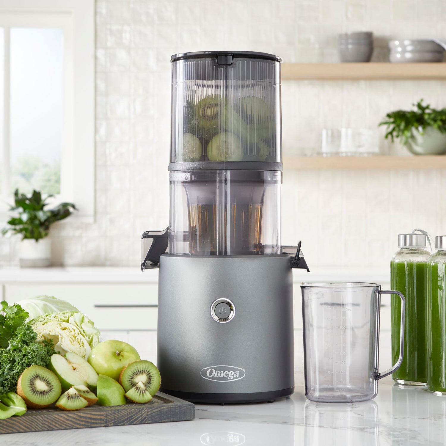Omega Cold Press Hands-Free Juicer and a glass on a kitchen counter