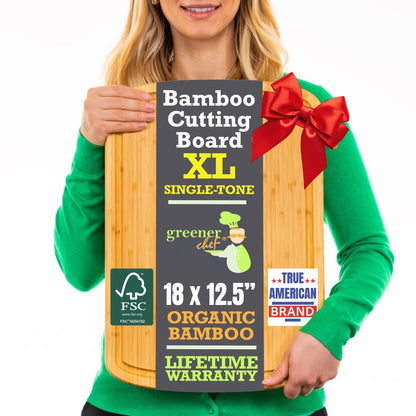 Person holding a bamboo cutting board with a red bow, brand labels, and product details.