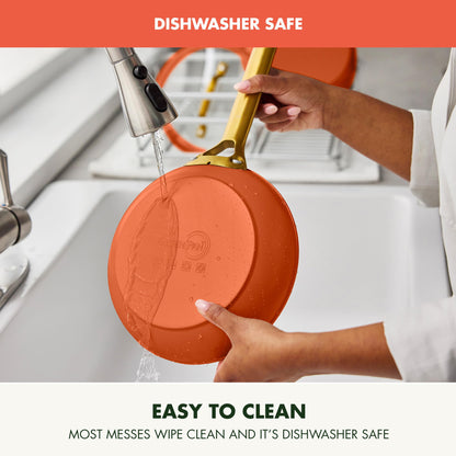 Person washing an orange silicone trivet under running water with text indicating it is dishwasher safe and easy to clean.