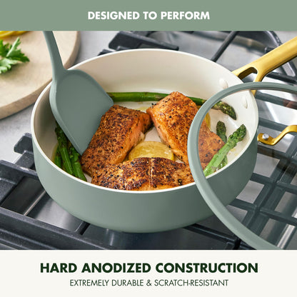Cooking scene with salmon and asparagus in a green pot on a stove, featuring text about hard anodized construction.