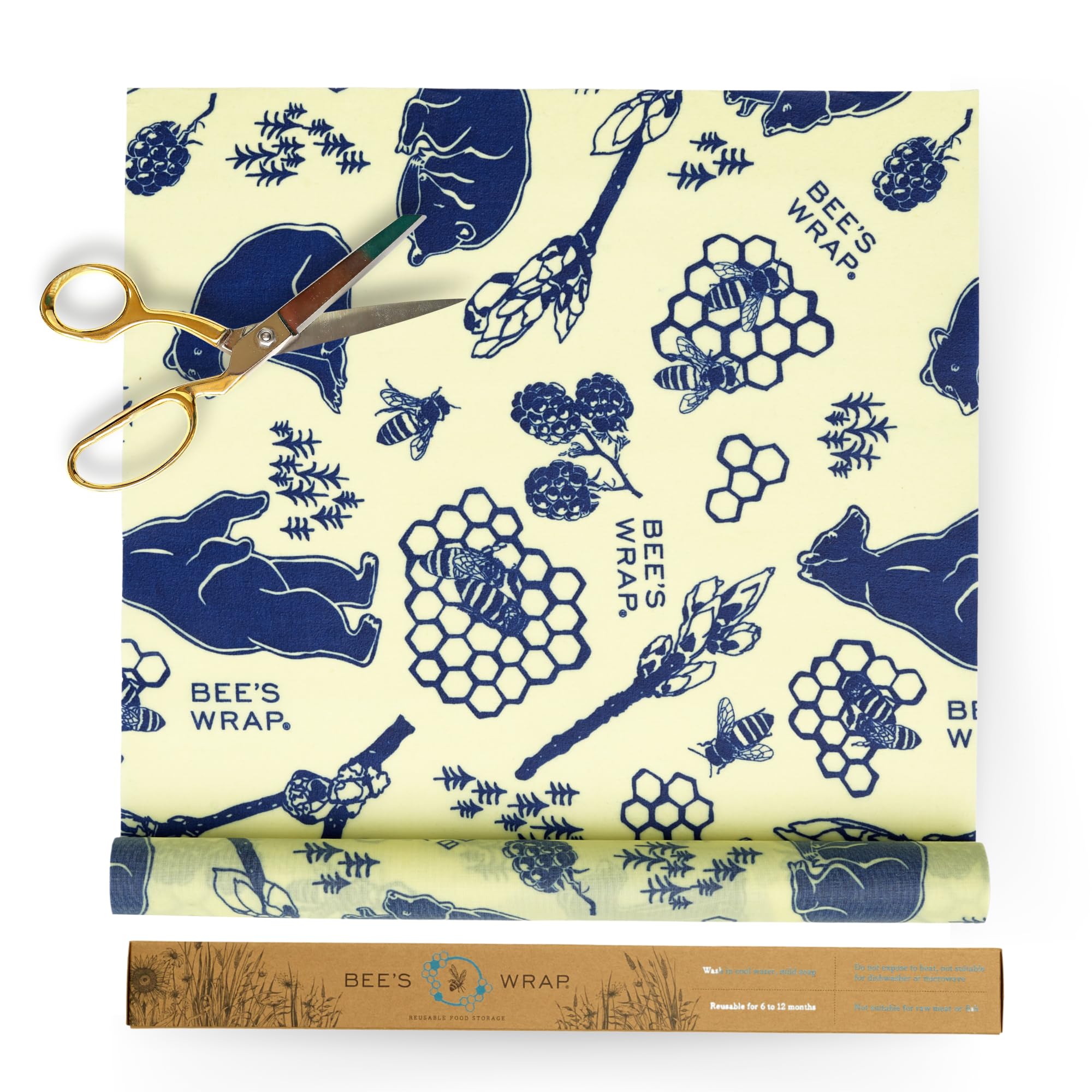 Roll of Bee's Wrap with blue bee and honeycomb pattern on a white background, accompanied by a pair of gold scissors.