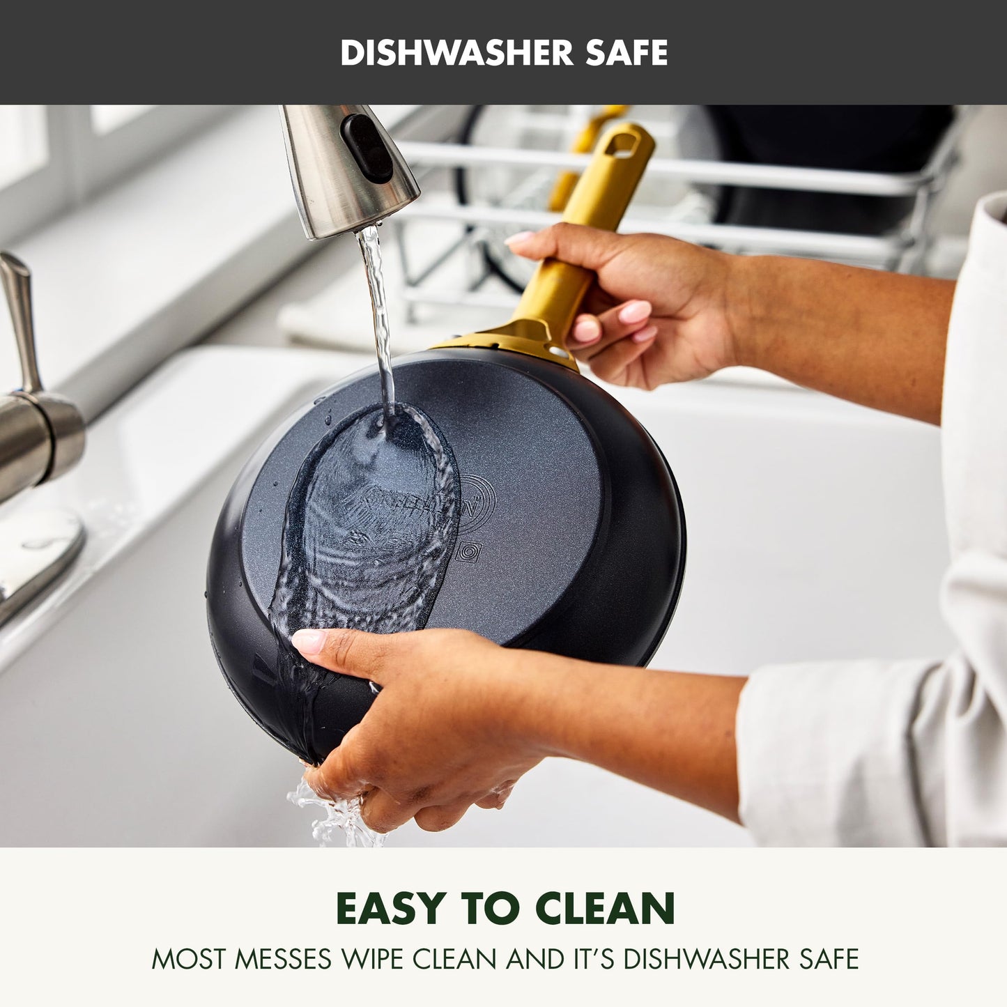 Person rinsing a black frying pan under running water with text indicating dishwasher safety and ease of cleaning.