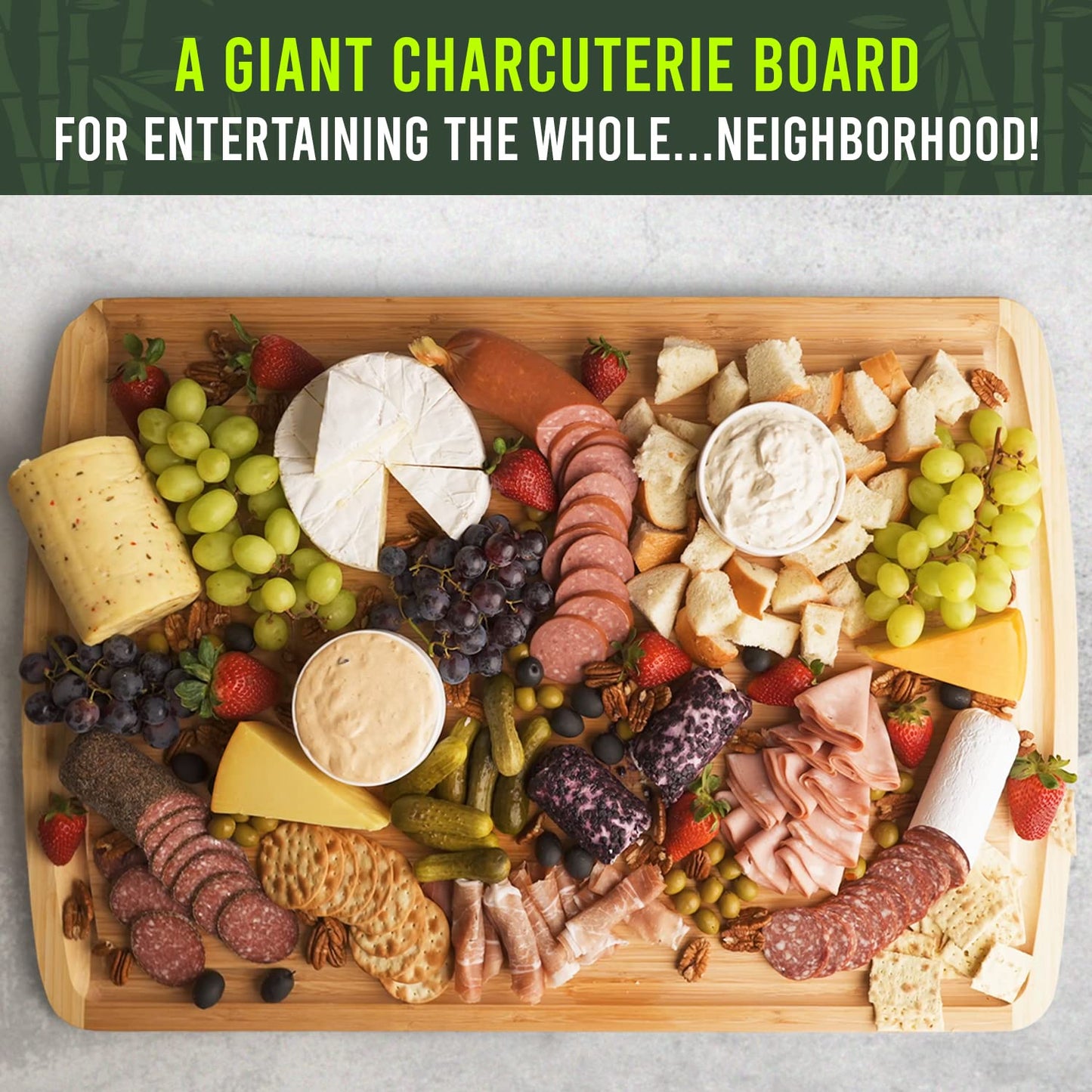 Giant charcuterie board with various meats, cheeses, fruits, and crackers on a wooden board.