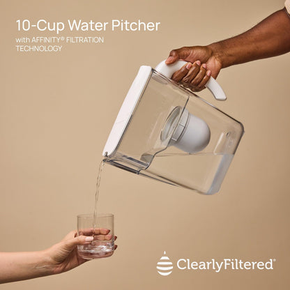 10-Cup Water Pitcher with Affinity Filtration Technology being used to pour water into a glass on a beige background.