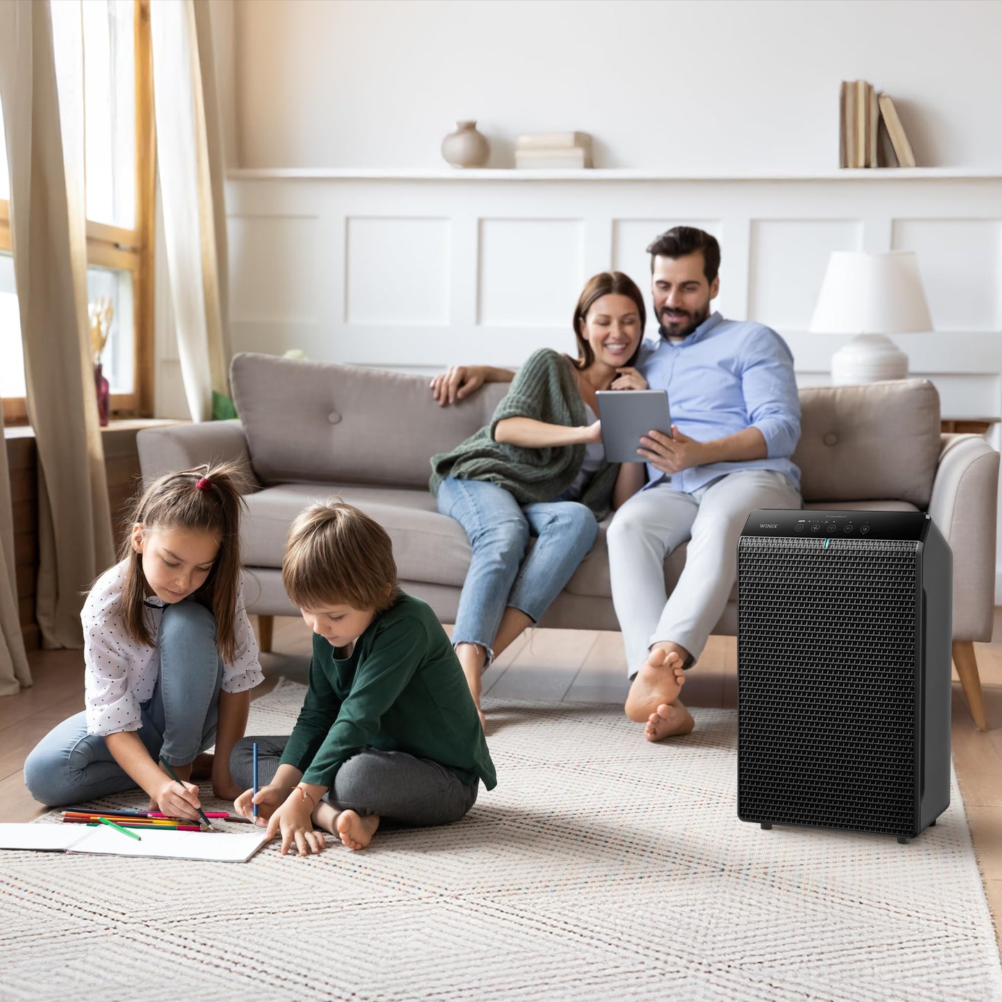 Family in a living room with an air purifier on the floor