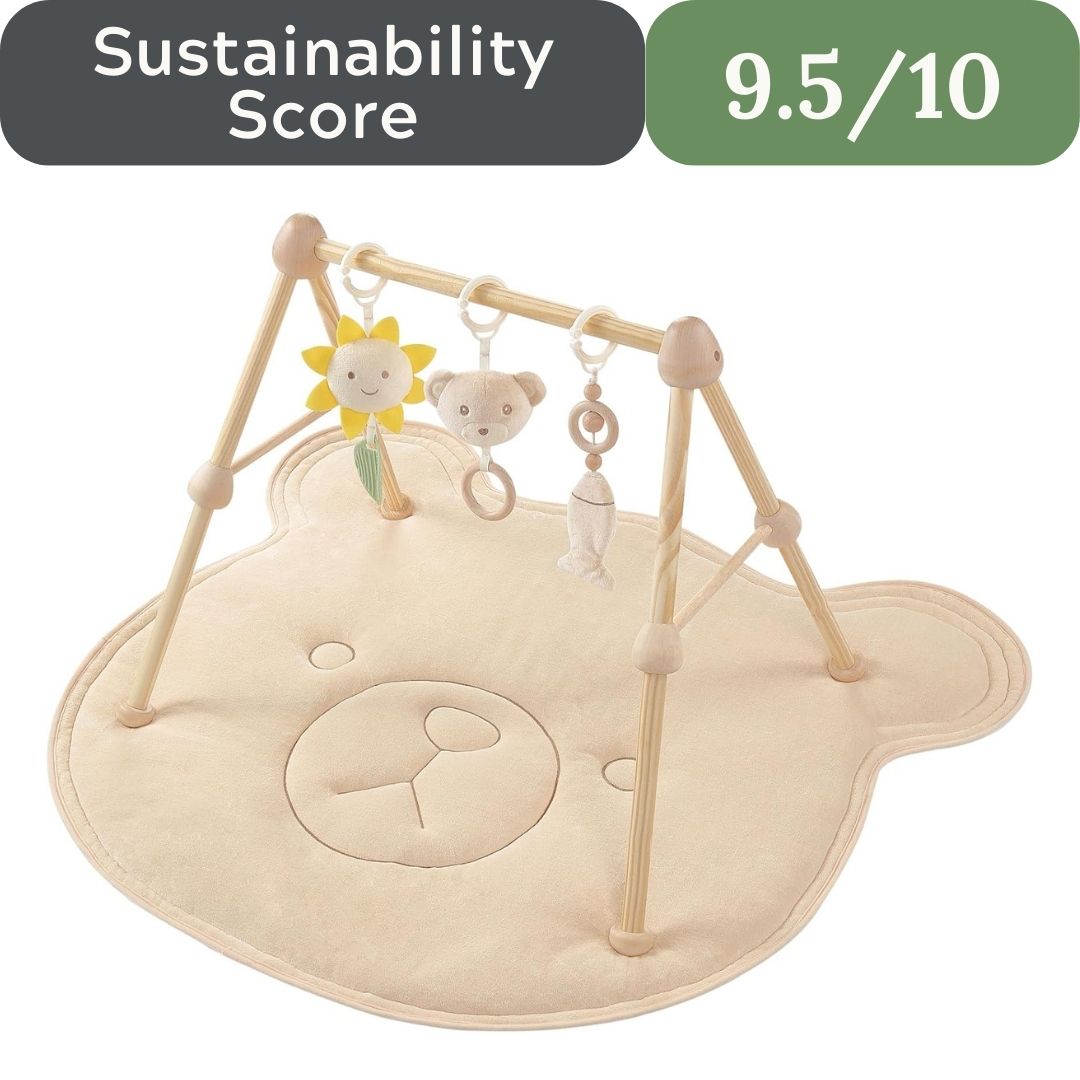 Baby play gym with toys on a white background, featuring a sustainability score. Wooden Activity Gym with Cotton Play Mat for non-toxic baby development in USA 2026